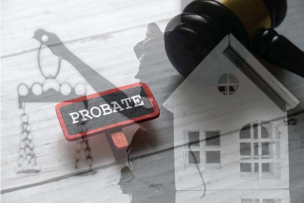A red PROBATE sign, a judge's gavel, and a model house arranged on a surface with shadow illustrations of legal and property icons.
